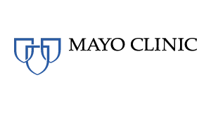 Mayo Clinic logo with three overlapping blue shields on the left and the words “MAYO CLINIC” in black capital letters on the right, all on a light gray background.