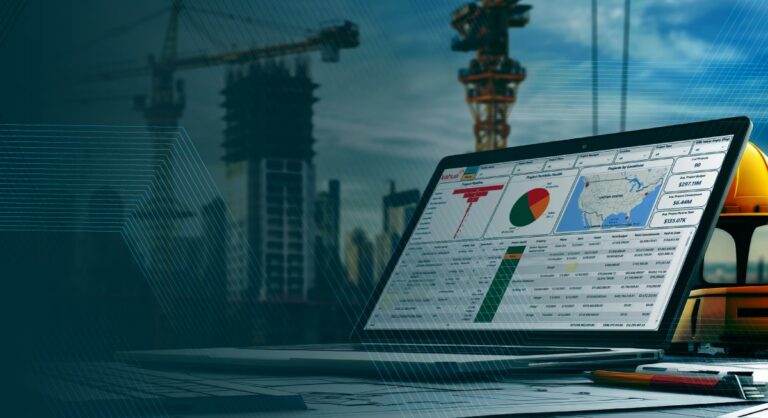 A laptop on a desk displays charts and maps on its screen, set against a construction site backdrop with cranes and buildings under construction. A yellow hard hat sits nearby.