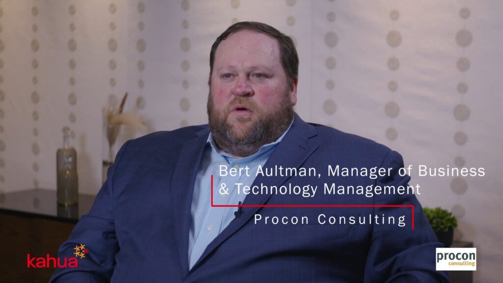 A man in a blue suit sits for an interview. Text on the image identifies him as Bert Aultman, Manager of Business & Technology Management, Procon Consulting. Kahua and Procon Consulting logos are visible.