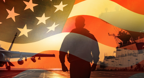A silhouette of a person walks on an aircraft carrier with a jet nearby, overlaid by a translucent American flag, evoking a patriotic military theme.