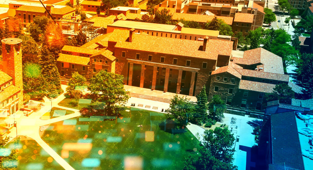 Aerial view of a university campus with red-roofed buildings, green lawns, trees, walkways, and colorful sunlight effects overlaying the image.