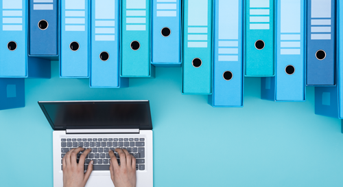 A person types on a laptop surrounded by rows of blue and turquoise file folders arranged neatly above on a light blue background.