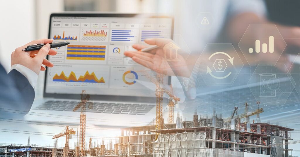 Two people discuss business data on a laptop with colorful graphs, overlaid with financial icons, and a background showing a construction site with cranes and a building under development.