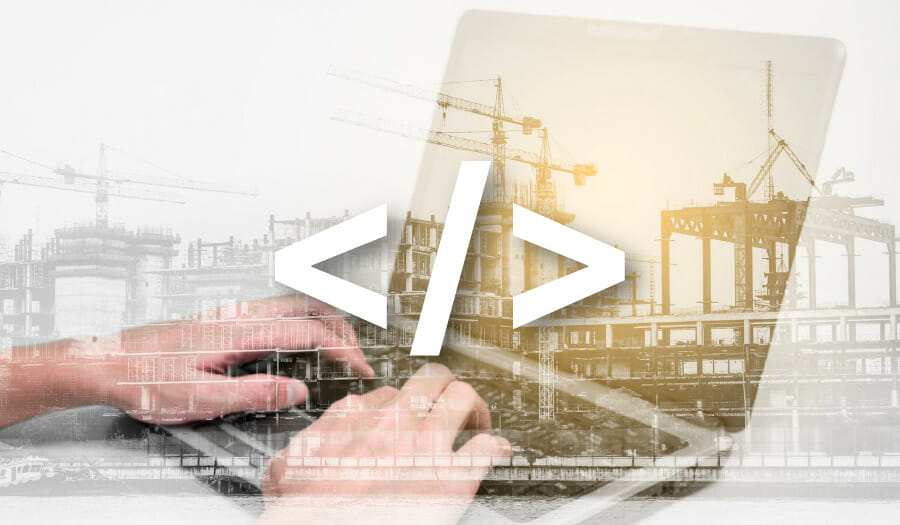 Hands typing on a laptop with a large code symbol overlaid; background shows construction cranes and building frameworks, blending themes of technology and construction.