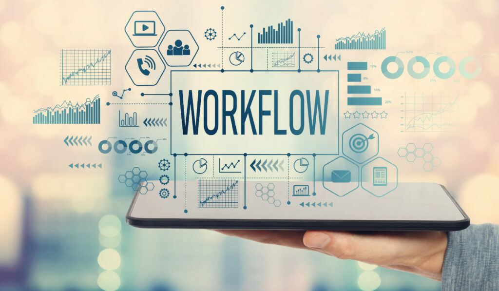 A person holds a tablet displaying the word WORKFLOW, surrounded by icons and charts representing business processes and data analytics.