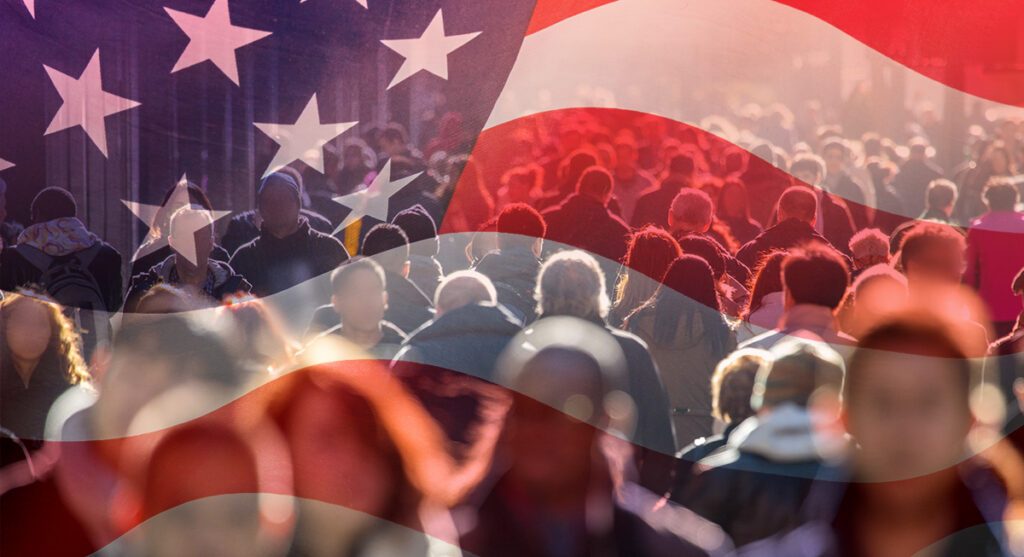 A large crowd of people walks outdoors, overlaid with a semi-transparent American flag, symbolizing diversity in the United States.