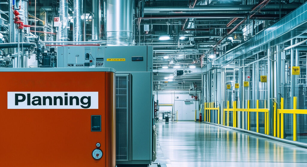 An industrial facility interior with metal pipes, machinery, and a large orange unit labeled Planning on the left. Bright lighting and safety railings line the empty, polished floor.