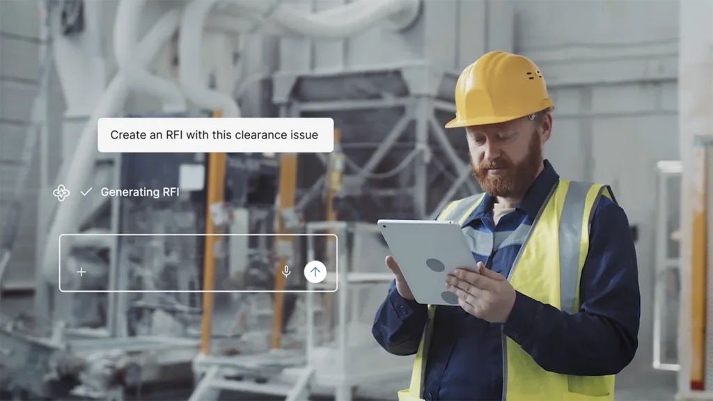 A construction worker wearing a yellow hard hat and safety vest uses a tablet in an industrial setting. Onscreen text reads Create an RFI with this clearance issue and Generating RFI..