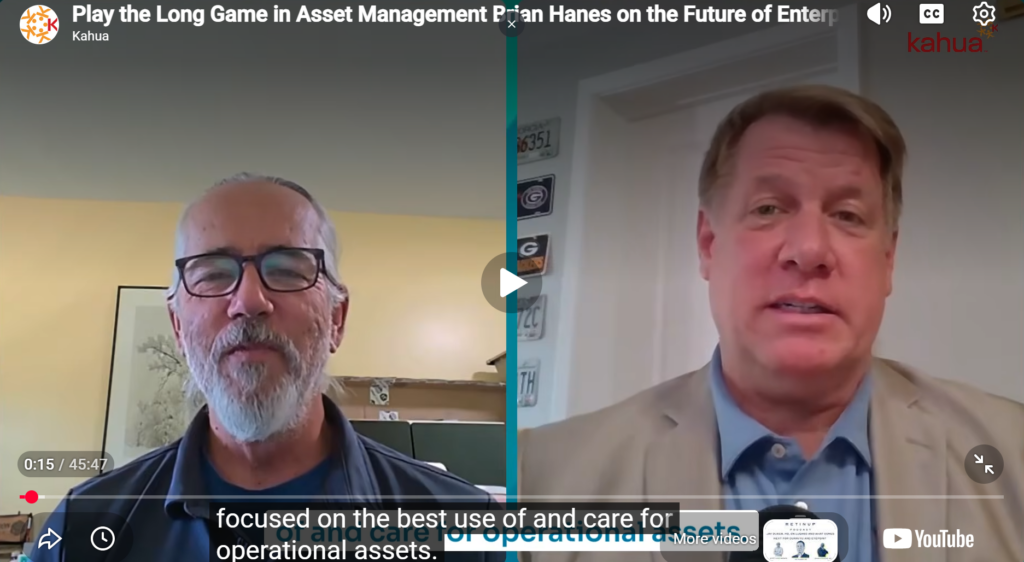 Screenshot of a video call featuring two men speaking, split down the middle. The left man has glasses and a beard; the right man has short hair and wears a suit. On-screen text and YouTube controls are visible.