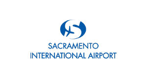 Blue logo with a stylized airplane and globe above the text Sacramento International Airport on a light gray background.