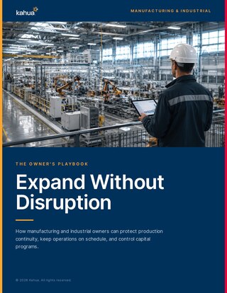 A person in a hard hat and safety vest observes machinery in a large industrial facility. Text reads, Expand Without Disruption. How manufacturing and industrial owners can protect production continuity..